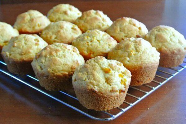 Vegan Cornbread Muffins photographed straight on while they are sitting on a cooling rack.