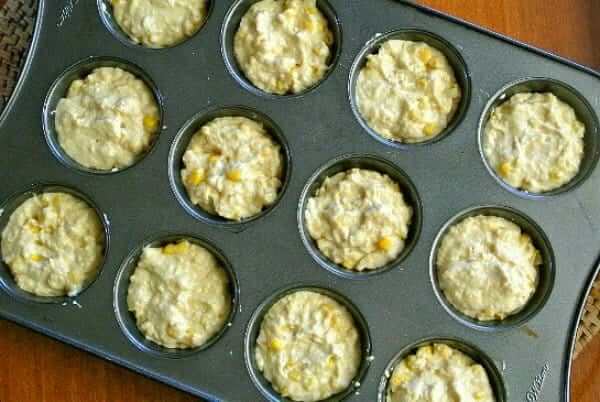 Vegan Cornbread Muffins photographed from overhead and raw in their muffin tin cups.