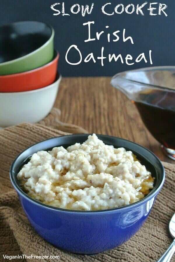 Slow Cooker Irish Oatmeal is filling a blue porcelain bowl with maple syrup drizzled over the top. Text at top for social sharing.