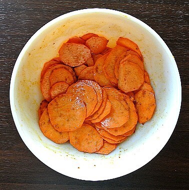 Air Fryer Sweet Potato Chips are in a bowl and tossed with spicy seasonings.