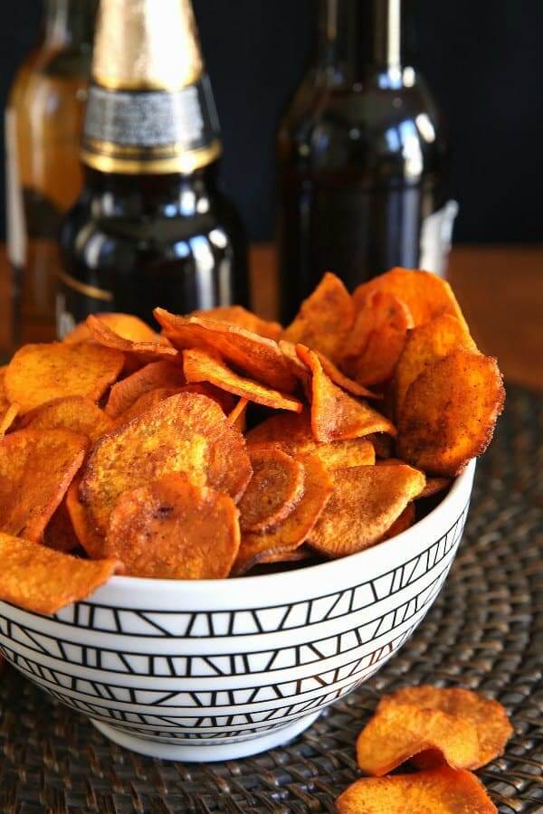 Snacks are overflowing a geometric black and white bowl.