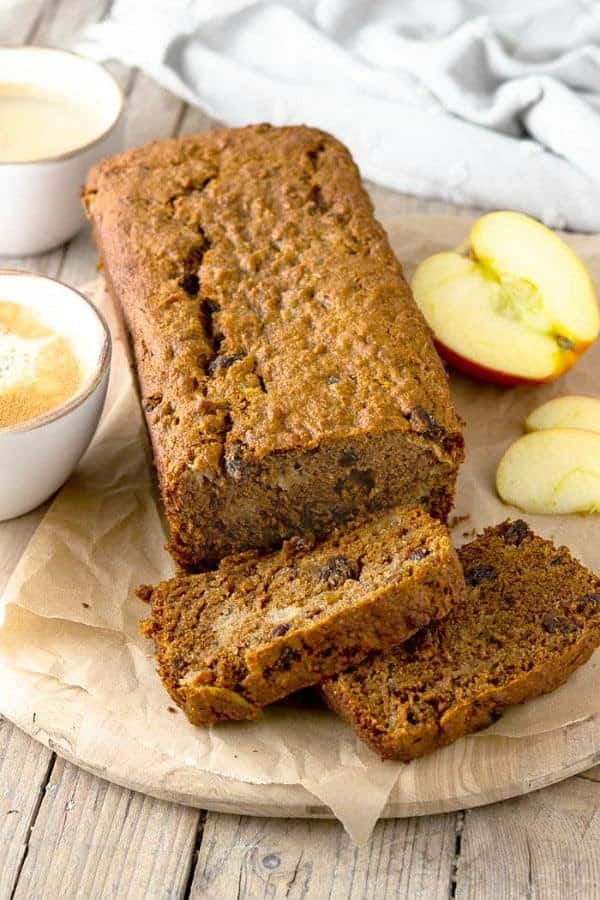 An overhead view of a loaf of applesauce bread and two slices ready to be enjoyed.