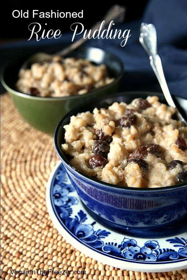 Straight on view of a cropped blue bowl full of creamy old fashioned rice pudding.