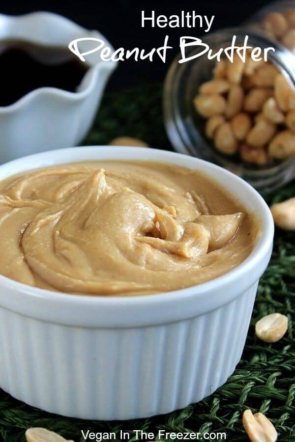 Close up view of creamy peanut butter swirled in a white bowl.