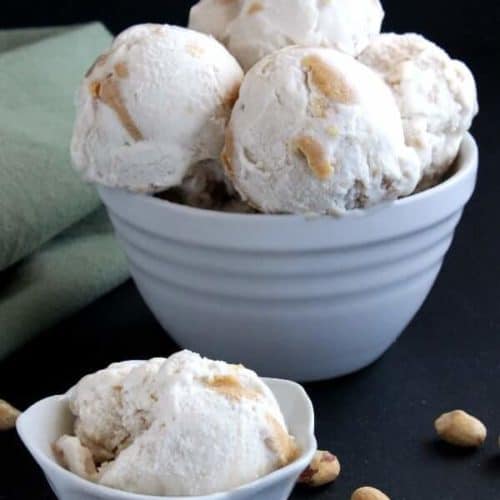 A white bowl with % huge scoops of ice cream with one single scoop and bowl in front.