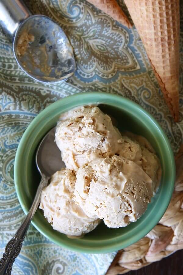 Overhead photo of four scoops of ice cream and a scoop laying beside using Biscoff cookies butter.