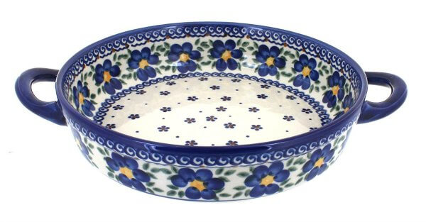 Close-up view of Polish pottery in blue, ivory and gold.