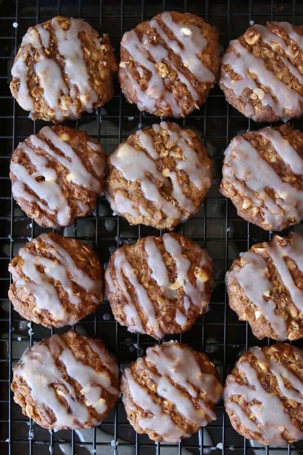 Overhead view of oatmeal cookies with a icing drizzle going back and forth across the tops.