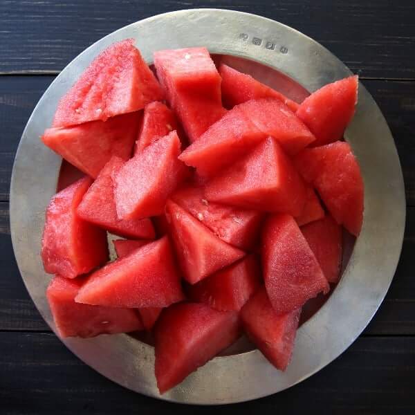 Overhead photo os watermelon with the rind cut off and cut into chunks.