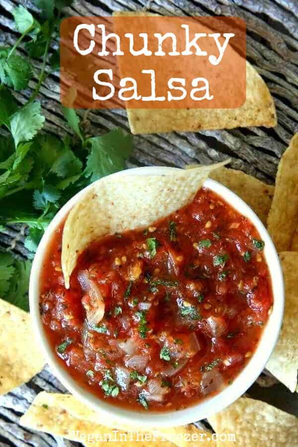Overhead photo of chunky salsa in a white bowl garnished with cilantro.