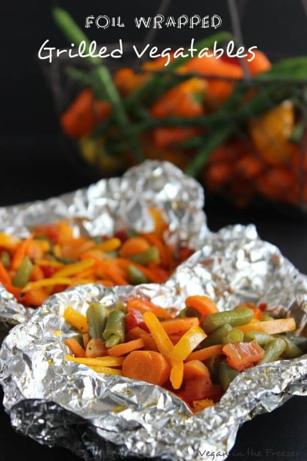 Two opened foil packets showing cooked orange, green and yellow veggies with text above.