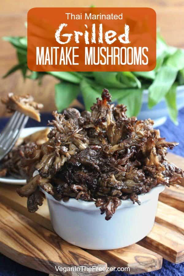 Front view of marinated Maitake mushroom side dish sitting on a wooden trivet.