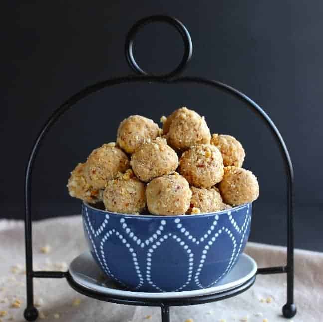 Square photograph of peanut butter balls in a blue and white bowl.