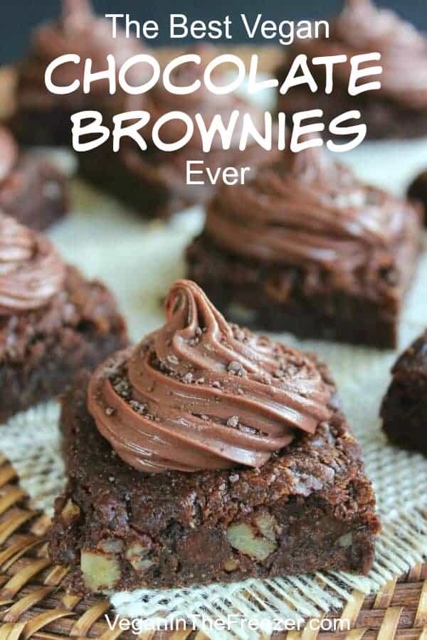 A Single chocolate brownie filled with peanuts and a twirl of chocolate frosting.