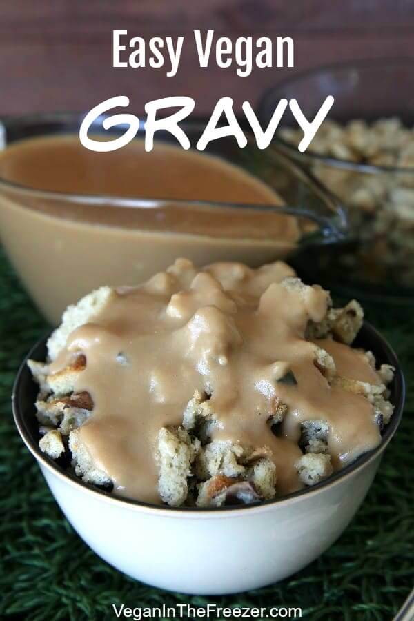 A bowl full of mushroom stuffing is covered with creamy vegan brown gravy on a green mat with text above.