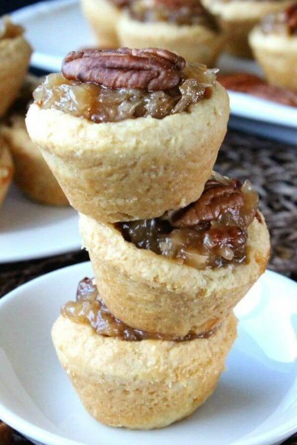Stack of three mini pecan pies tilting this way and that.