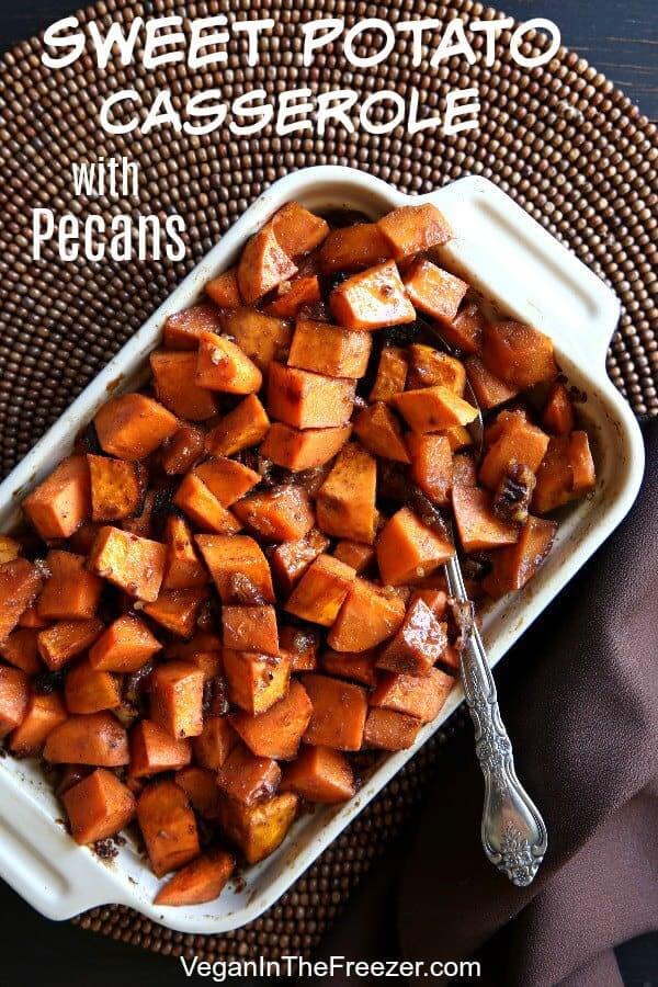 Overhead photo of baked sweet potato casserole with pecans and a serving spoon inserted.