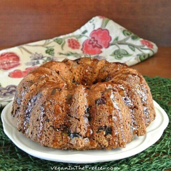 Front and center view of a whole glazed fruitcake bundt cake.