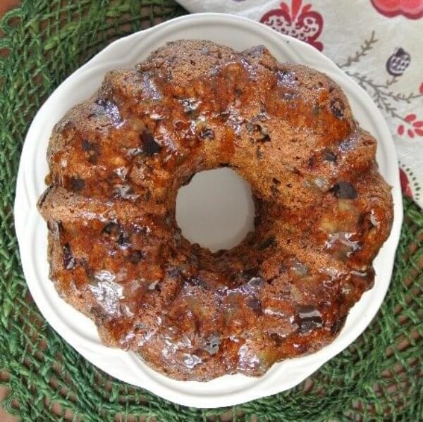 Overhead view of a square photo centering the glazed fruitcake.