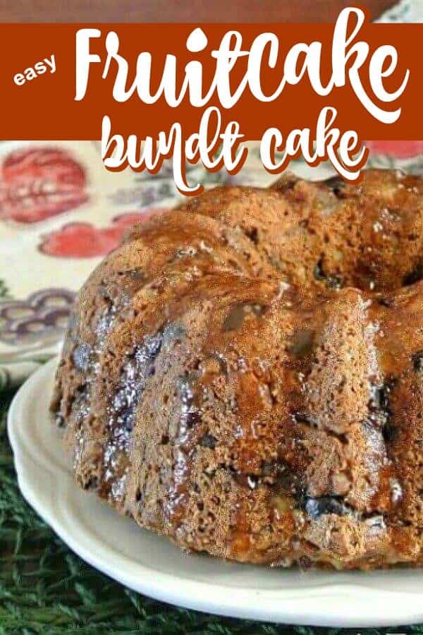 Close up photo of half of a bundt cake fruit cake with glistening glaze.