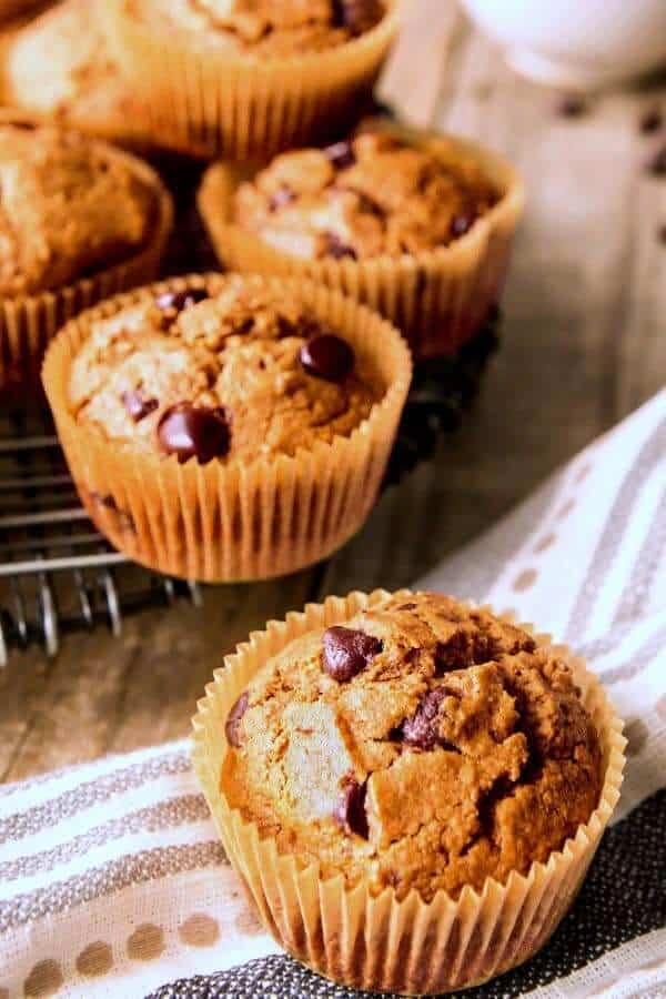 One healthy breakfast muffin in front in a muffin cup sitting on a polka dot cloth.