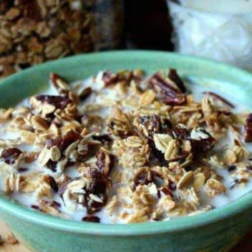 Close up photo and cropped on each side of the bowl filled with granola and milk.