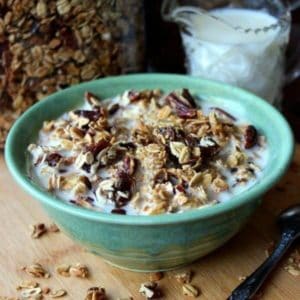 Front view of simple homemade granola cereal in a green pottery bowl.