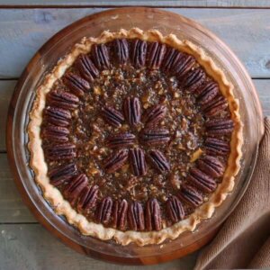 Overhead view of a healthy vegan pecan pie recipe in a glass plate.