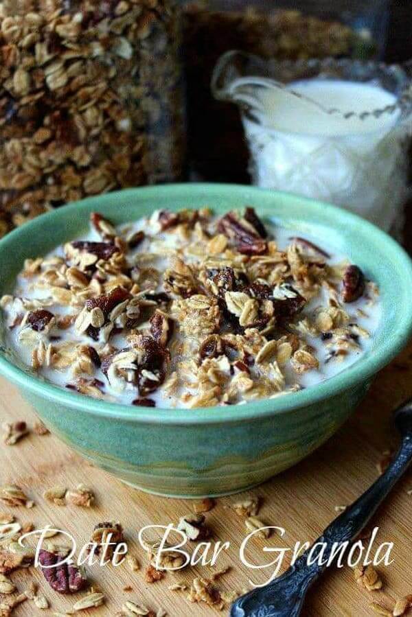 Tilted green pottery bowl filled with milk and date granola with script at the bottom.