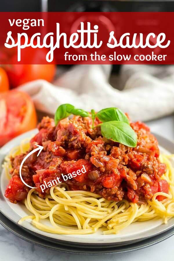Close photo of spaghetti sauce on a pile of spaghetti with basil on top.