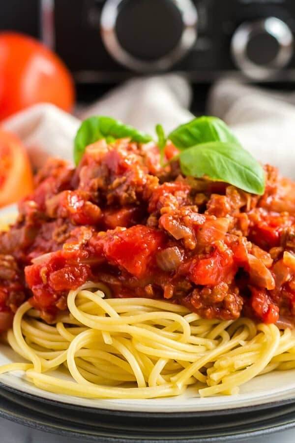 Up close photo of plant based pasta sauce on spaghetti.