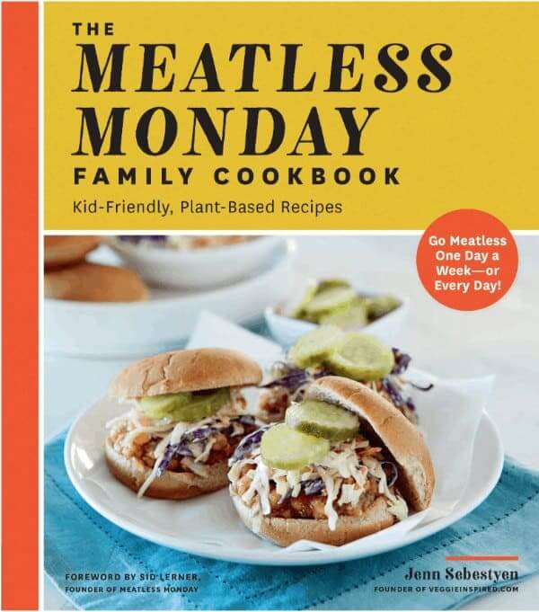 Front cover of the cookbook Meatless Mondays with a sandwich piled high on the cover.