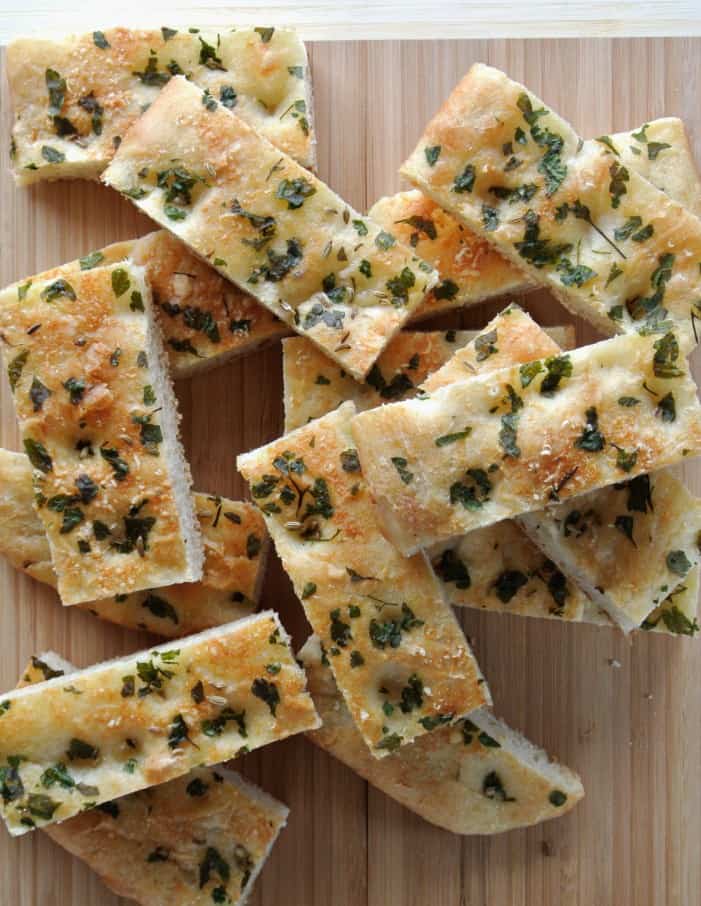 Overhead photo of thick slices of vegan focaccia bread angled in different directions.