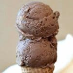 Two big scoops of vegan chocolate ice cream on a sugar cone.