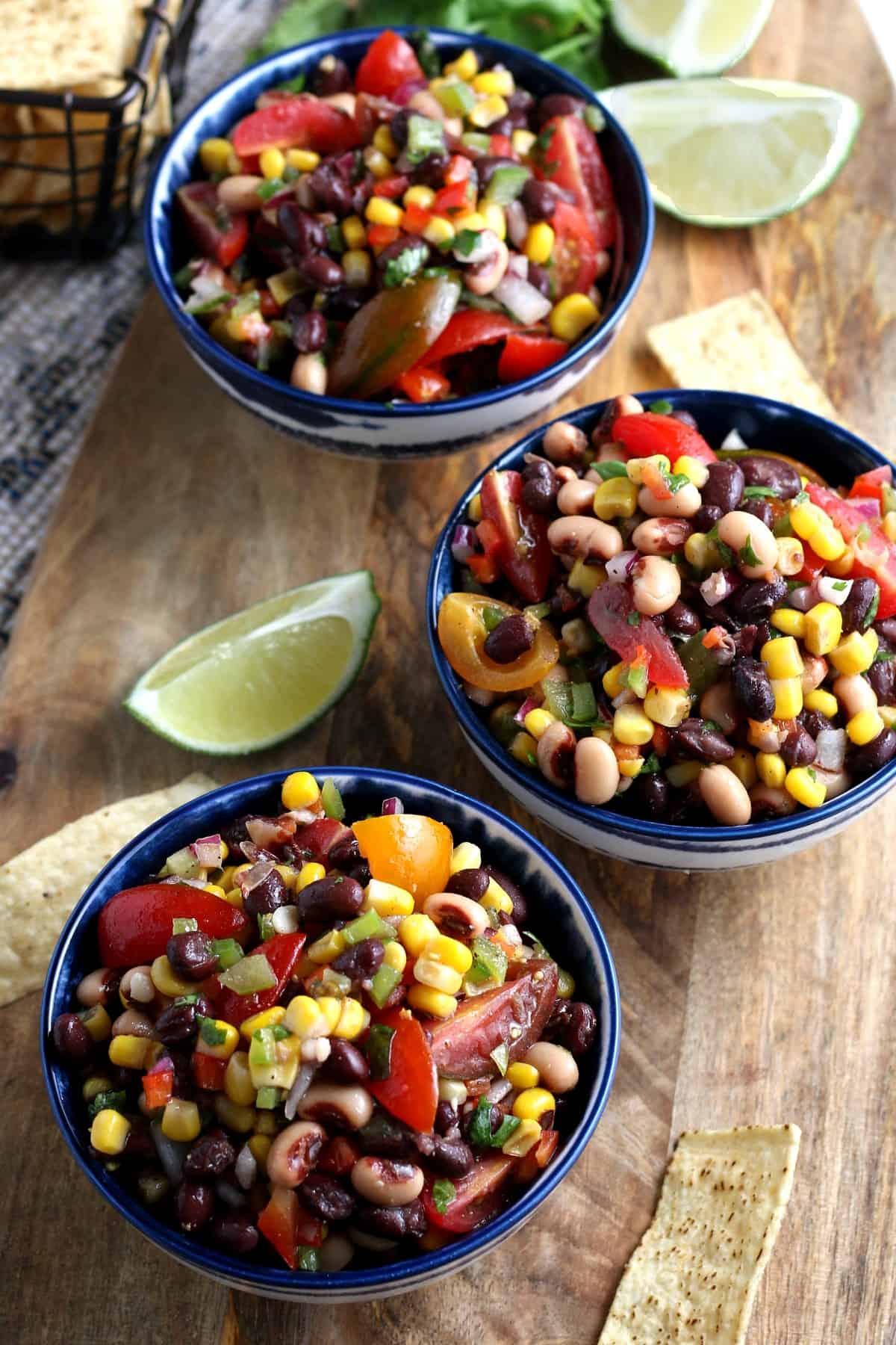 Three full bowls angled towards the camera and filled with fresh veggies for a dip or cold side.