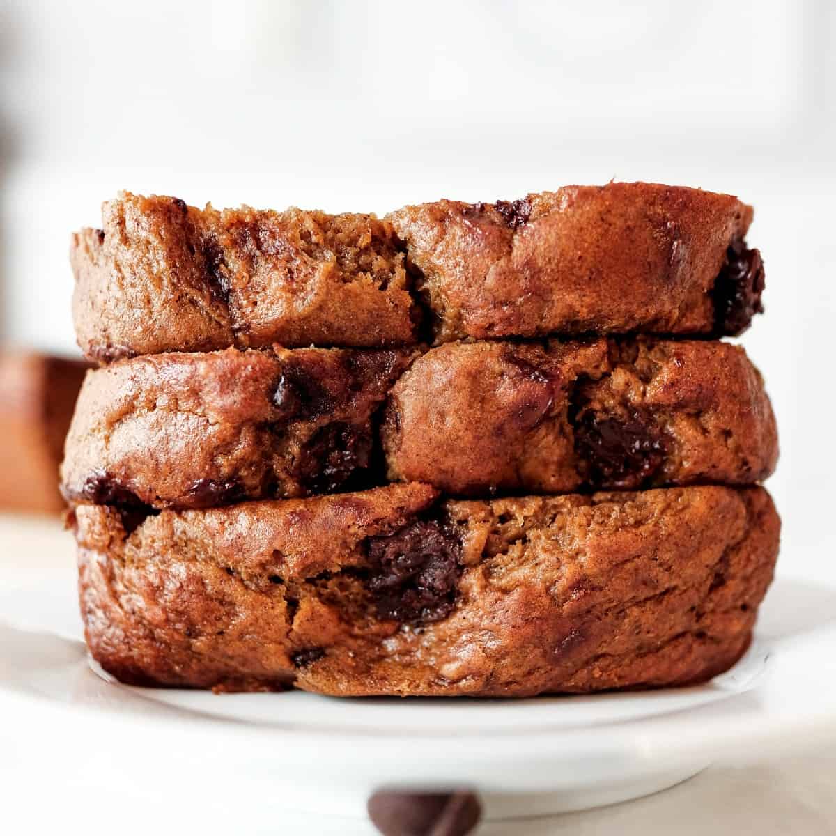 Front view of three stacked slices of chocolate chip banana bread filling the frame.
