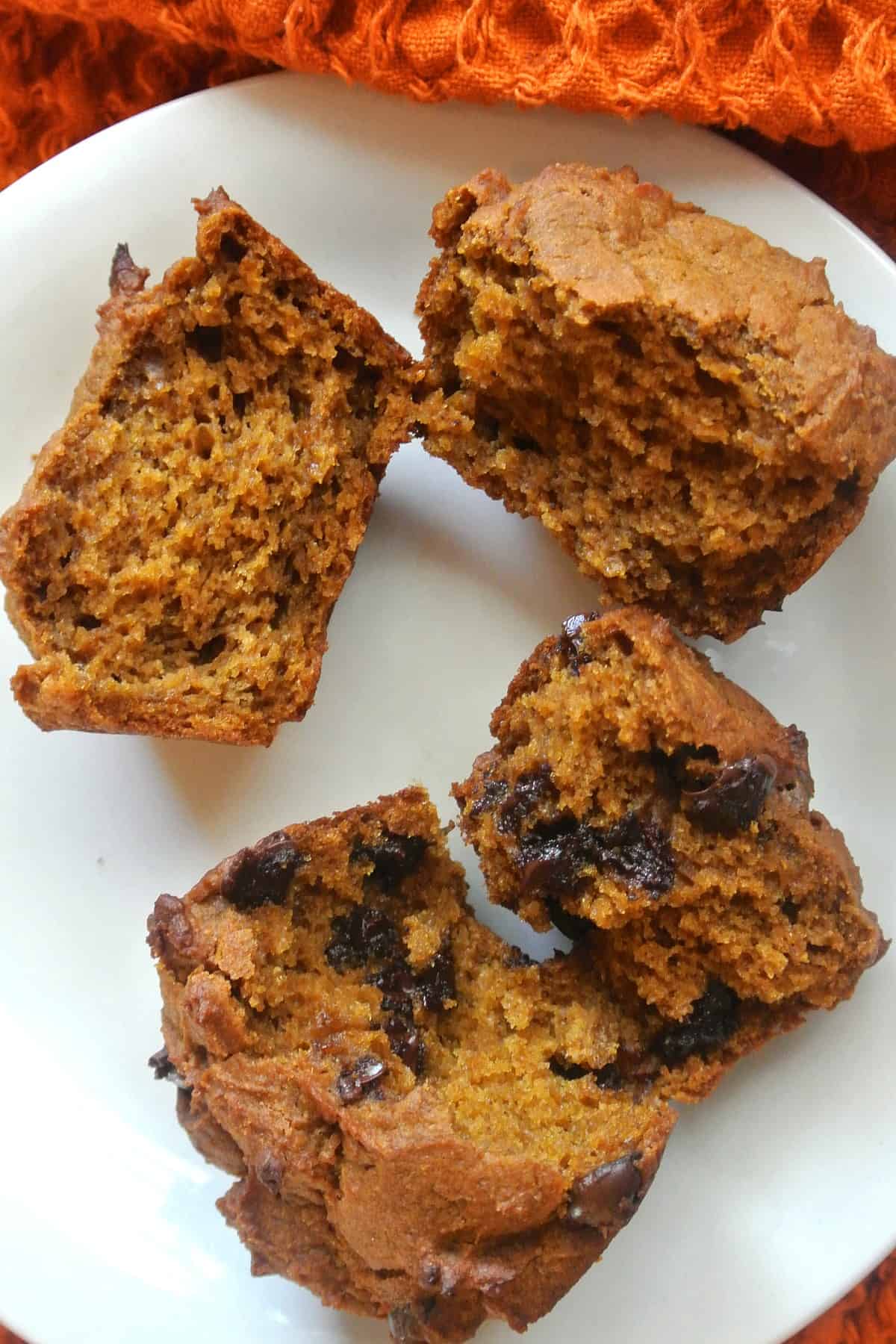 Two muffins laying open to show the insides with or without chocolate chips.