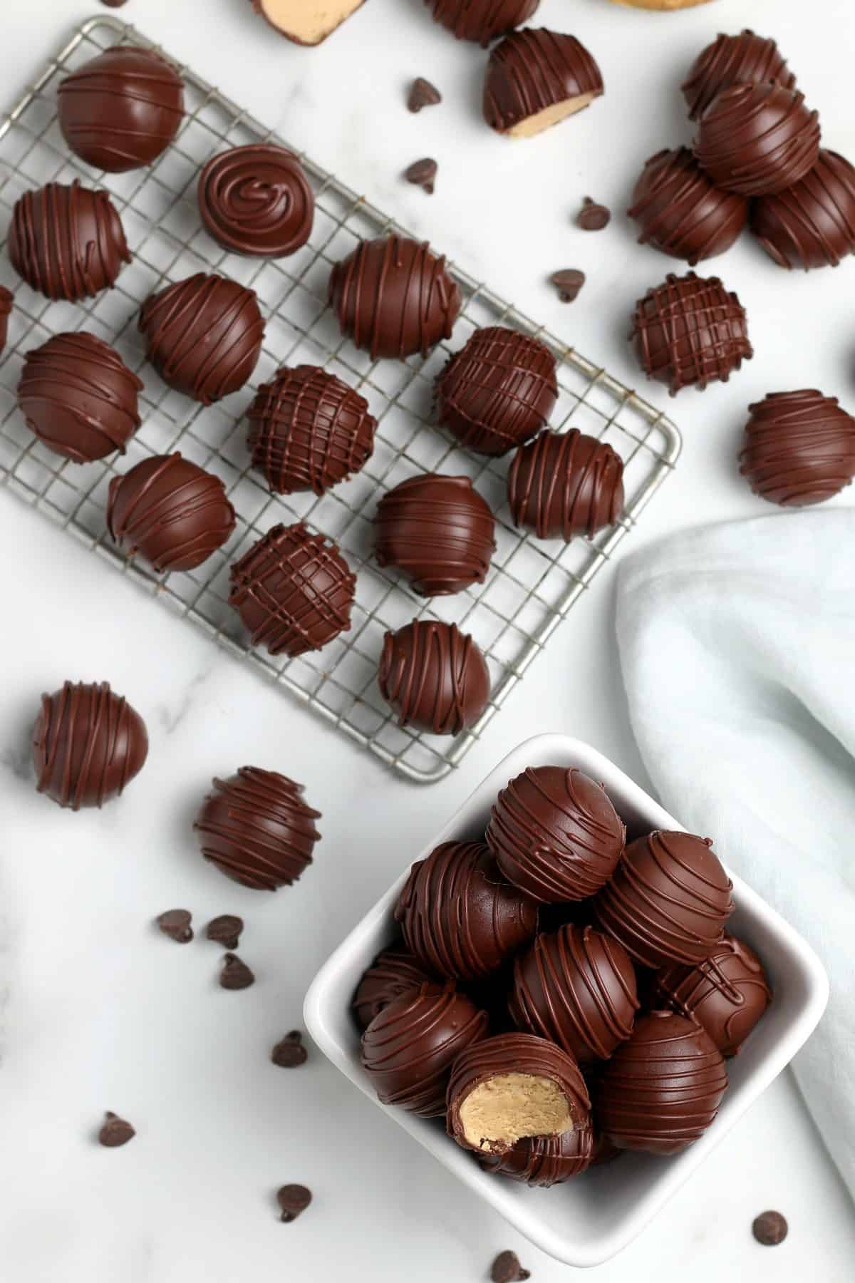 Overhead photo of peanut butter fudge truffles covered with chocolate drizzle patterns.