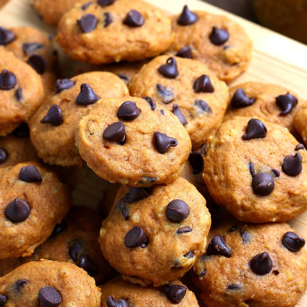 Close-up photo of a pile of vegan pumpkin chocolate chip cookies.