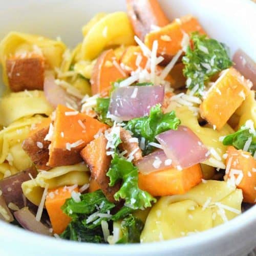 Close up photo of vegan cheese tortellini and sweet potatoes.
