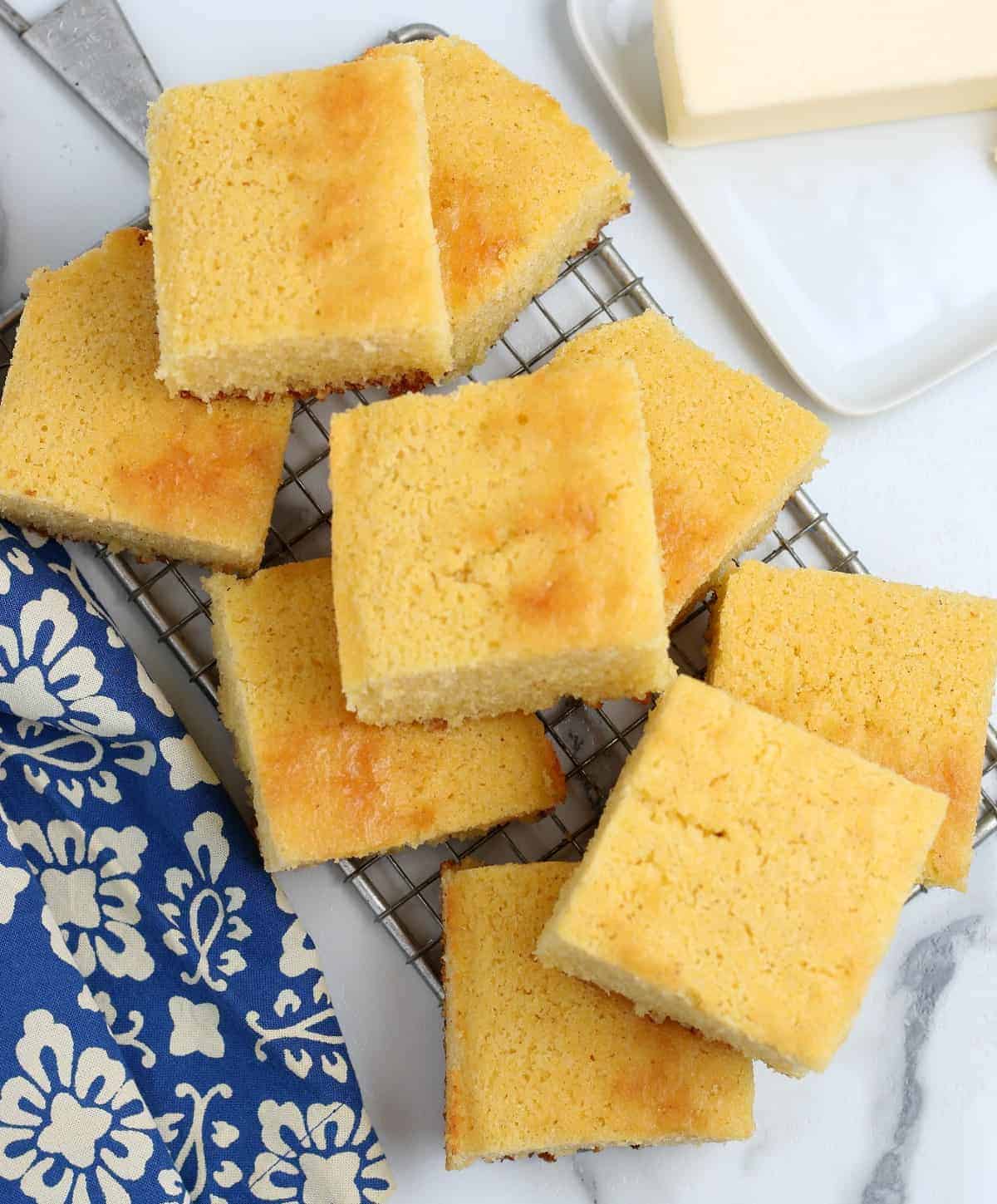 Overhead photo of many squares cut and stacked on a cooling rack.