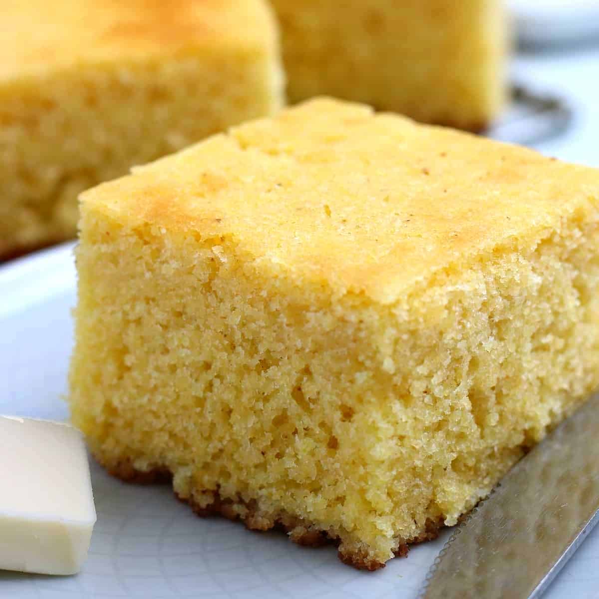 Close up view of a fat piece of cornbread.