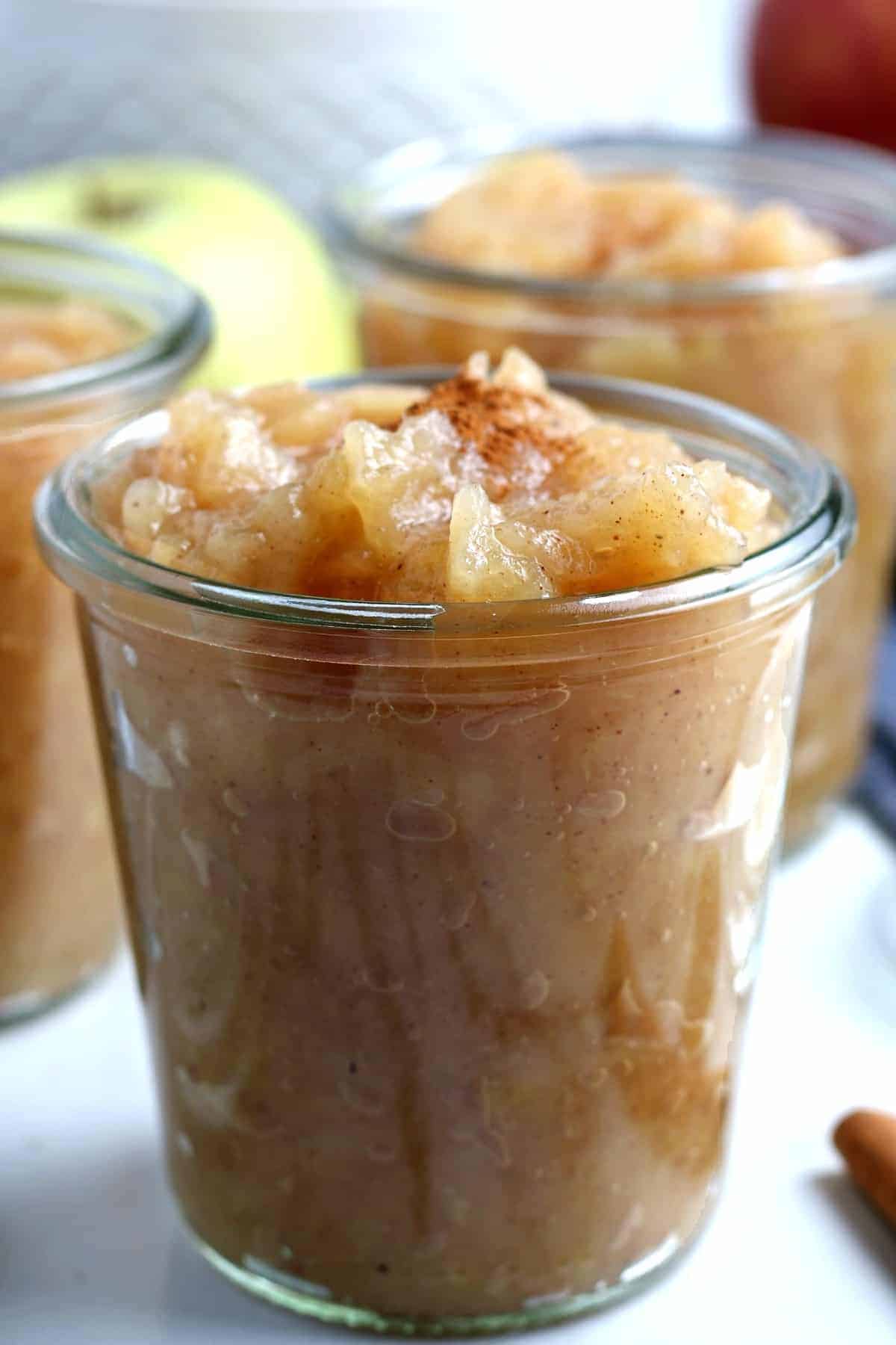 One center closeup of a clear jar full of a fruit side dish.