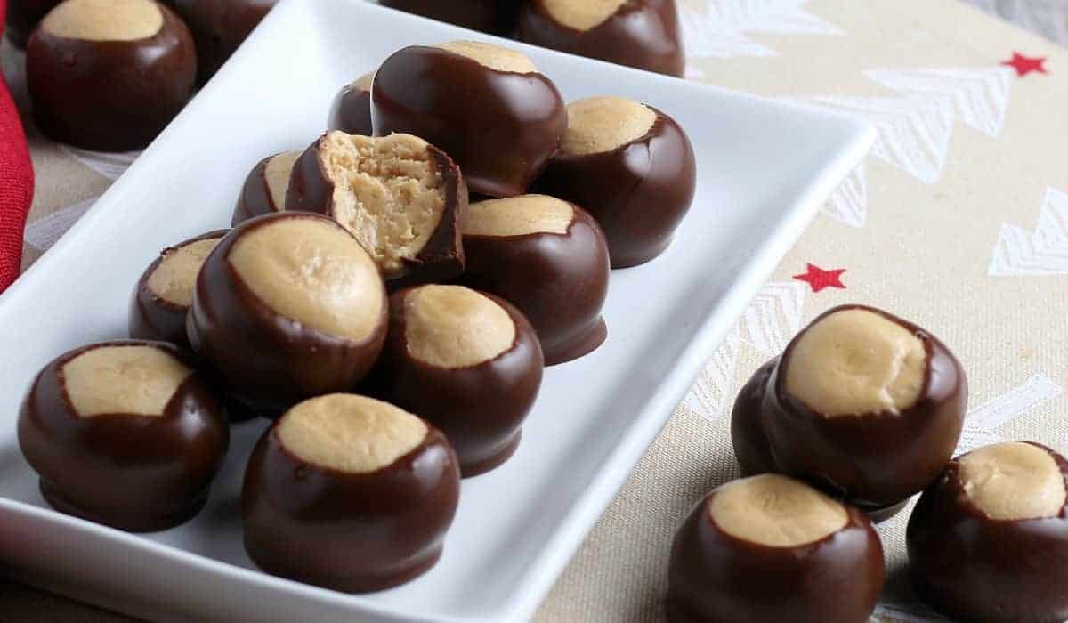 Finished buckeye candy in a rectangular plate and also on the side.