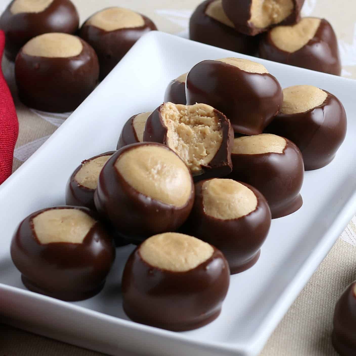 Buckeye candy recipe lined up on a rectangular plate.