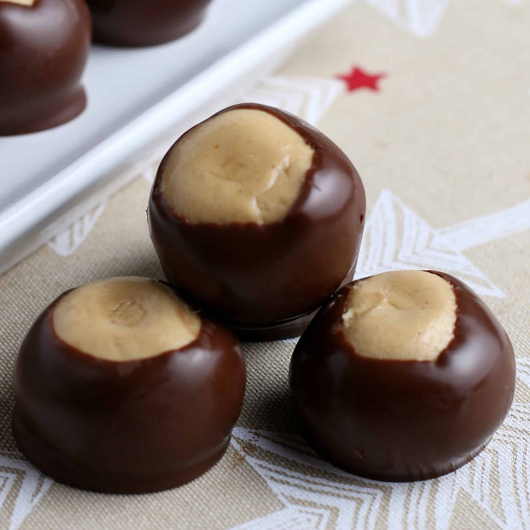 Three stacked peanut butter balls dipped in chocolate.