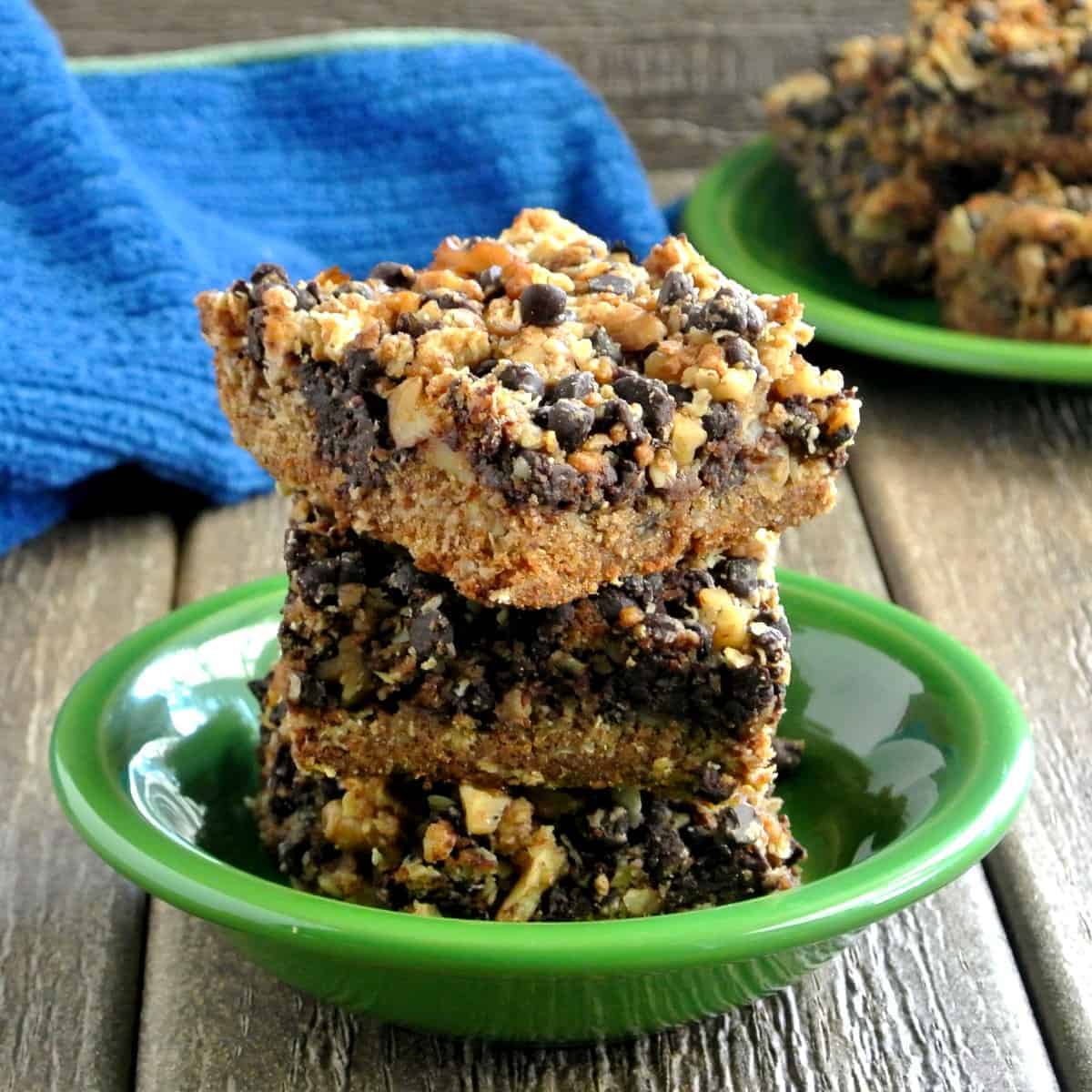 Chocolate Chip bars stacked on top of each other on a wooden picnic table.