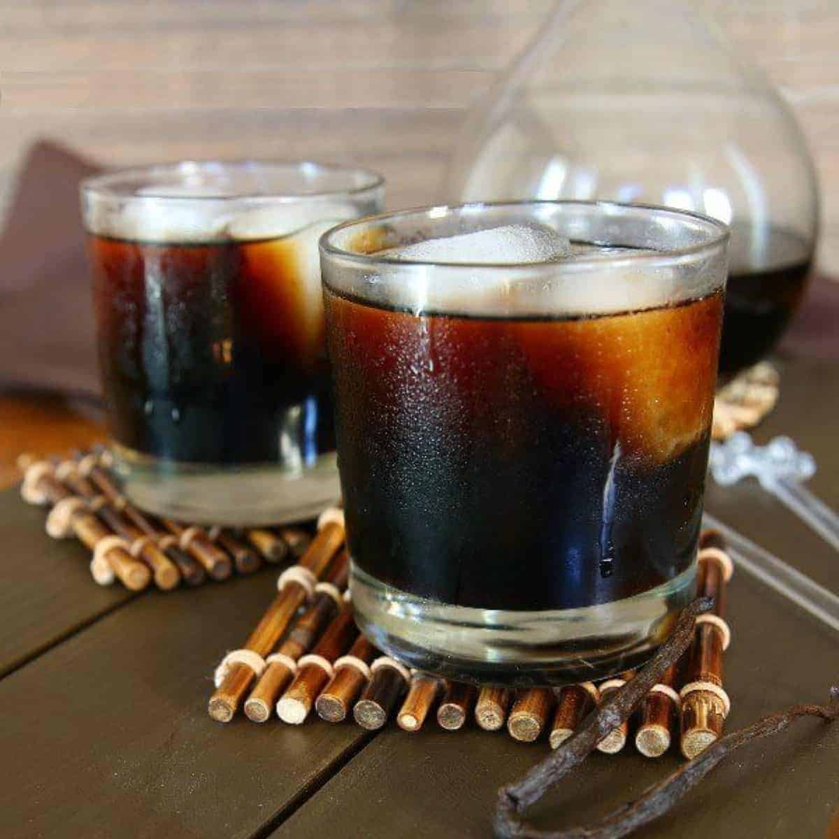Two glasses filled with ice and dark Kahlua.