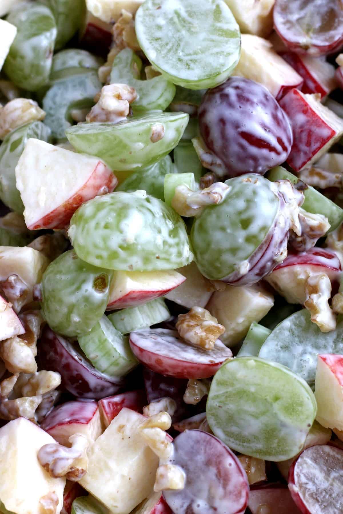 An extreme close-up of the tossed fruits and vegetables.