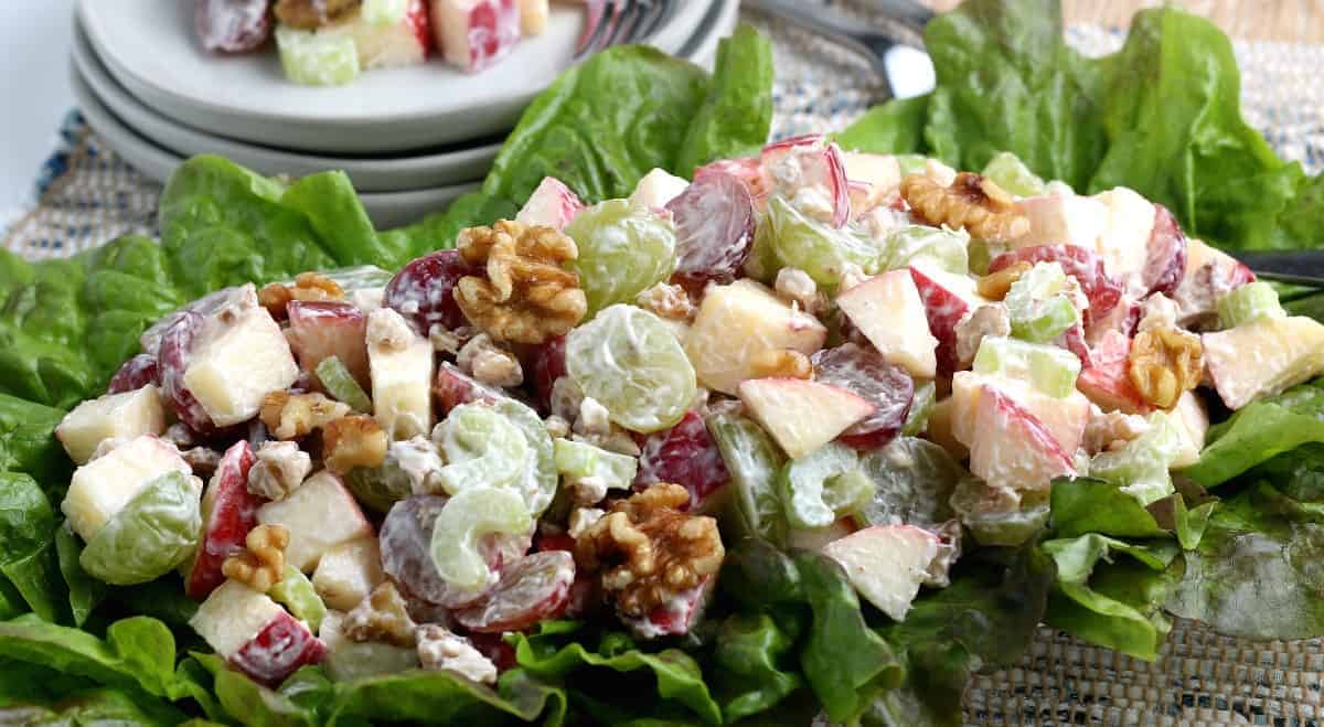 Wide view of a fresh fruit mix on a bed of lettuce.